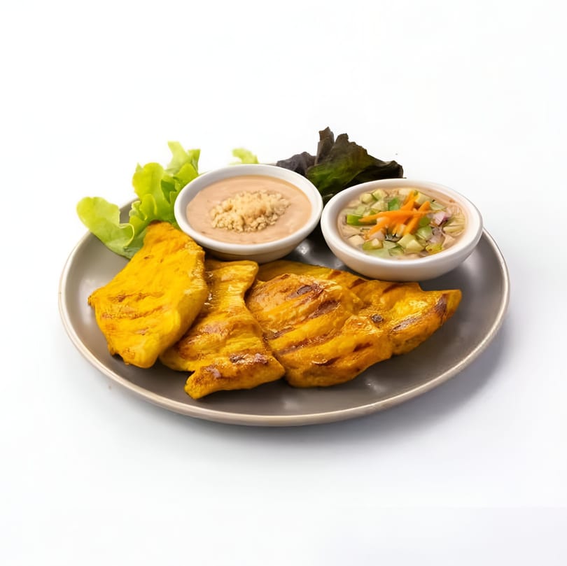 Skye Thai's grilled chicken satay with peanut sauce, cucumber relish, and fresh lettuce on a gray plate.